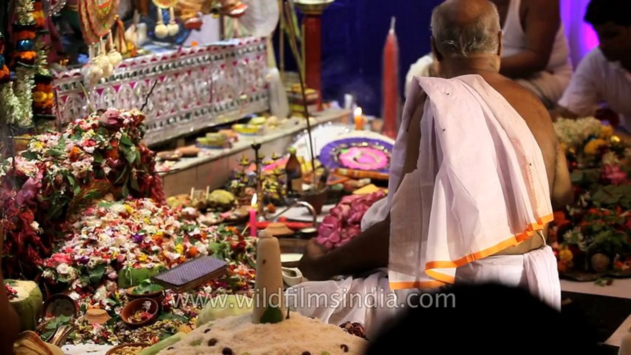 The Head Priest offers his prayers: Kolkata Durga Puja pandal
