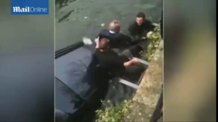 Men jump into river to save 60 year old sinking in car