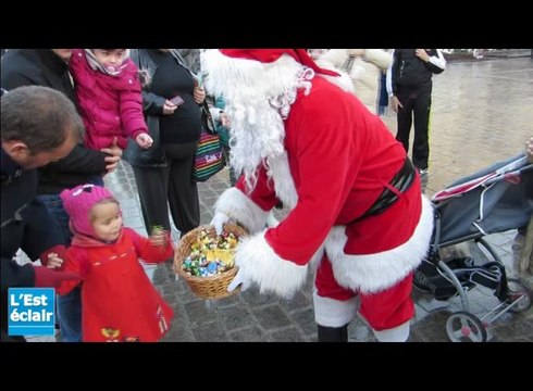 Le Père-Noël distribue des bonbons dans les rues de Troyes
