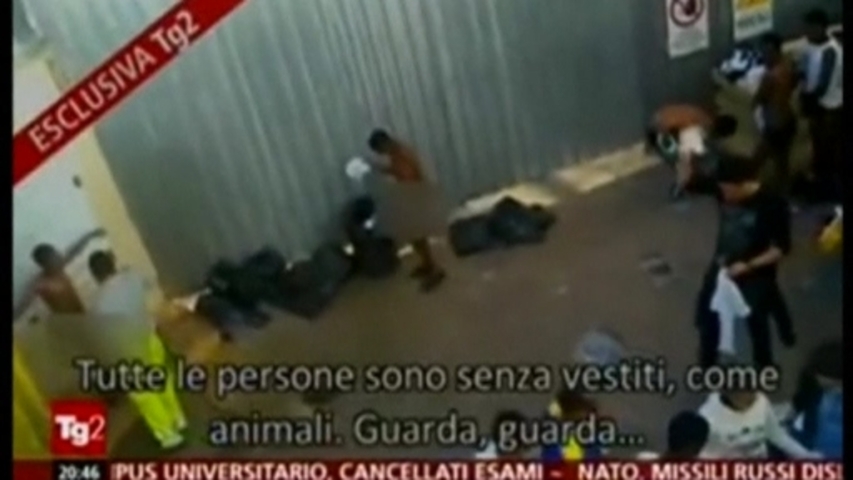 Naked migrants sprayed for scabies