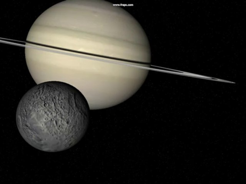 CU grey moon lower left orbits Saturn reverse rotation