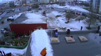 Snowboarder Makes An Amazing Roof Jump