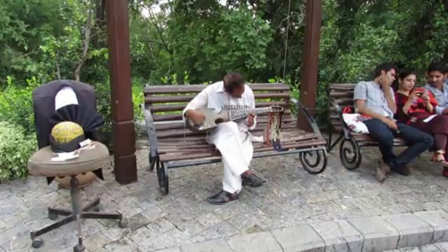 Folk musician playing Rubab at Daman-e-Koh Margalla Hills Islamabad Pakistan