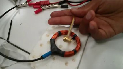 Aimant en rotation sous l'effet d'un courant alaternatif dans une bobine