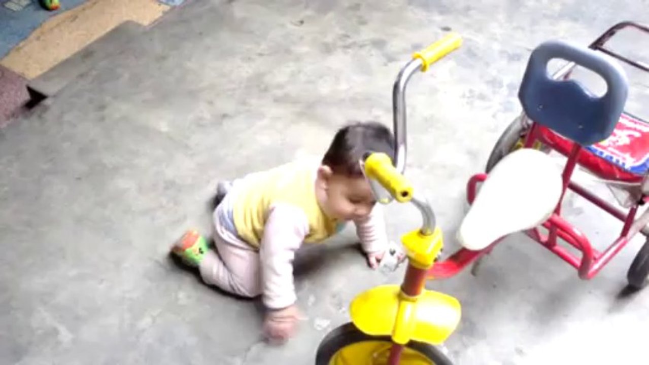 Baby playing with bicycle