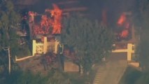 Brush fire destroys Los Angeles area home