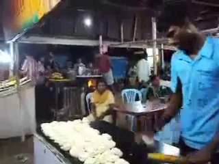 man throwing chapati