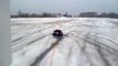 A car pulls a guy lay on the snow! Crazy dumb guy!