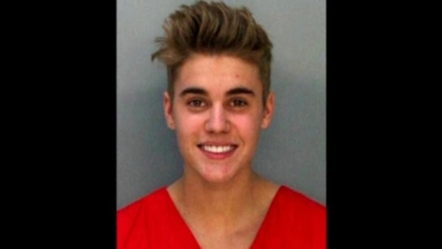 Justin Bieber grins for police