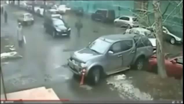 The car crashes into two parked vehicles