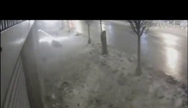 Pedestrian covered by snow on sidewalk... Crazy!