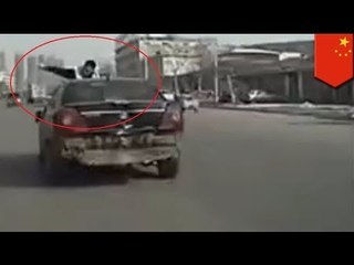 Chinese cop gets taken for 3km ride on car hood