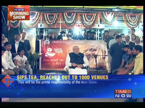 A cup of tea in hand, Narendra Modi reaches out