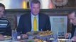 New York mayor Bill de Blasio eats pizza with knife and fork