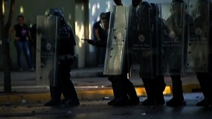 Demonstrators clash with riot police in Caracas