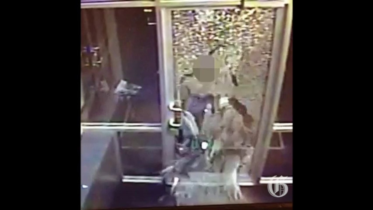 Video: Woman smashes through glass door