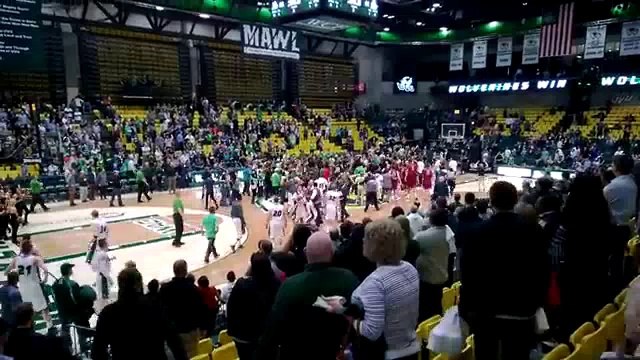 NCAA player punches fan after spectators storm court