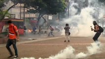 Rocks and tear gas fly as Venezuela protests heat up