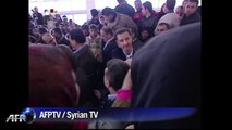 Syria's Assad visits displaced outside capital: state TV