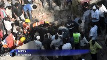 Search for survivors after building collapses in India