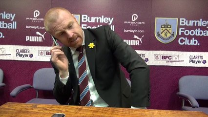 Burnley Manager Sean Dyche answers a journalist's phone in middle of post match press conference