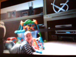 Neiklai plays and watches Baby Einstein