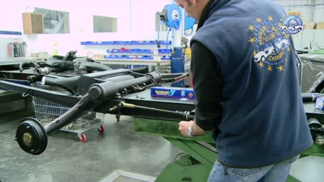 Changing a rear shock absorber.