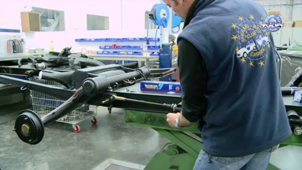 Changing a rear shock absorber.