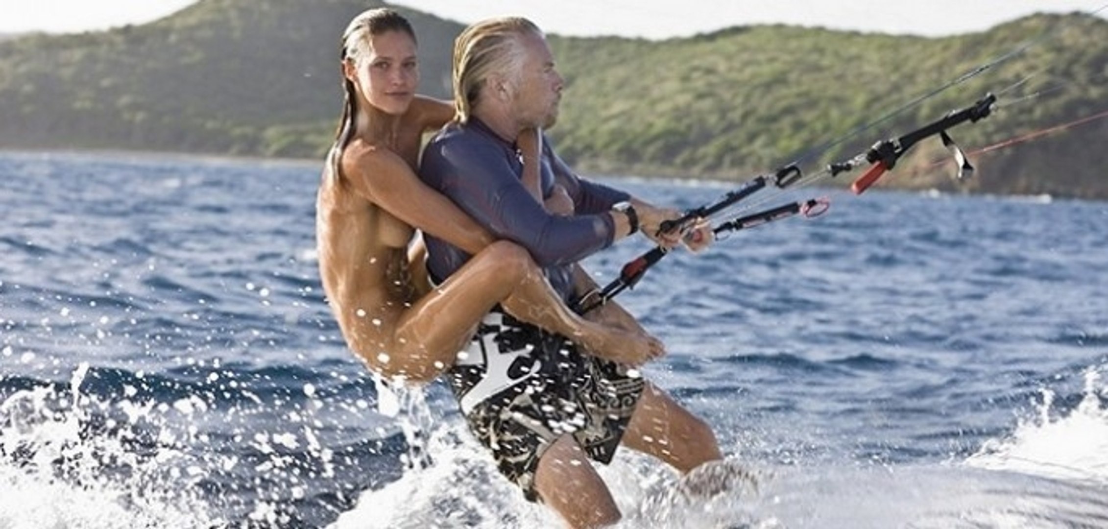 Richard Brandson kitesurfing with 3 girls on his back