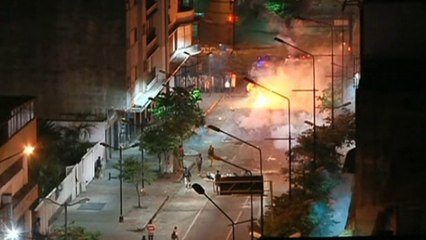 Protesters set fire to a police water cannon in Venezuela