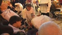 Pope washes and kisses feet of 12 sick and disabled people
