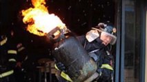 Chinese Firefighter Bravely Carries Burning Tank Out of Restaurant