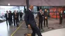 Barack Obama plays soccer with a robot in Japan