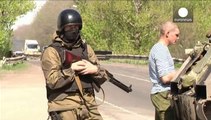 European military observers held in Ukraine are paraded before the press