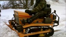 Struck mini dozer pushing snow