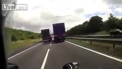 Motorcycle crash between two trucks