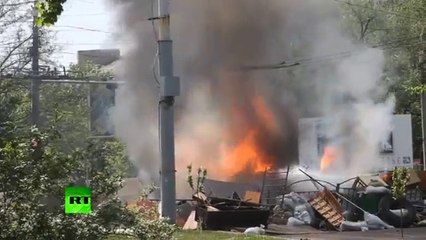 Shells explode as Ukraine army's APC set on fire in Mariupol