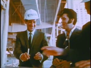 Elvis signing his contract to perform at the "International Hotel" in Las Vegas.