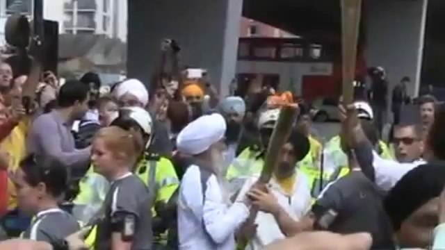 Fauja Singh Running with the Olympics Torch in London