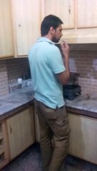 A boy  smoking Cigarette in Office Kitchen