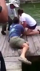 a fish bitting a man hand amazing...............