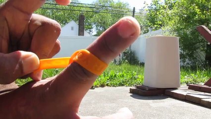 Man using arm band as slingshot.ARMBAND FINGER SLINGSHOT .