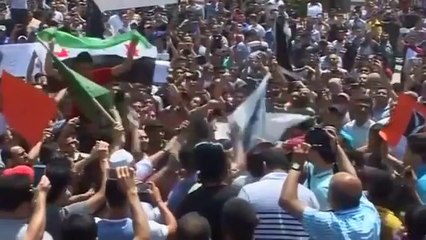 Bombs fall on Syria, as refugees protest upcoming election