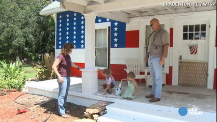 Family paints giant American flag on front of house