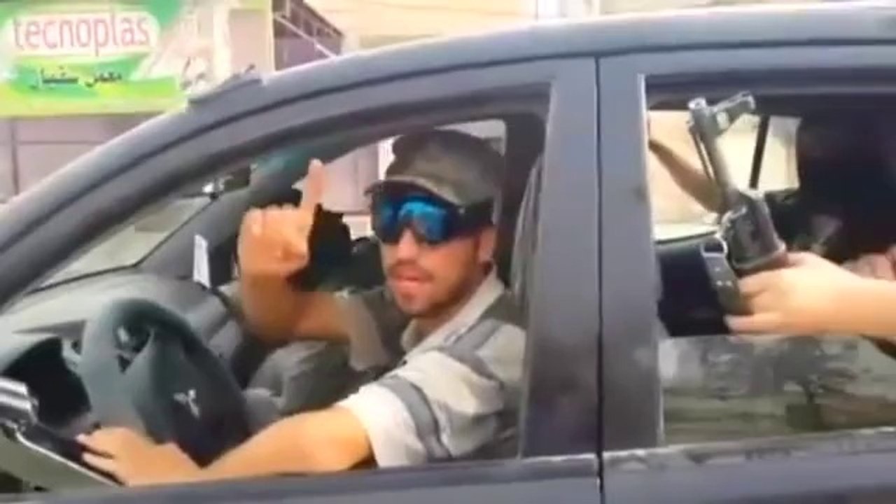 Islamic militants parade in captured Iraqi military vehicles