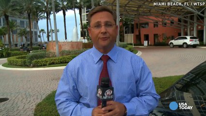 Couple looks on as house falls off cliff