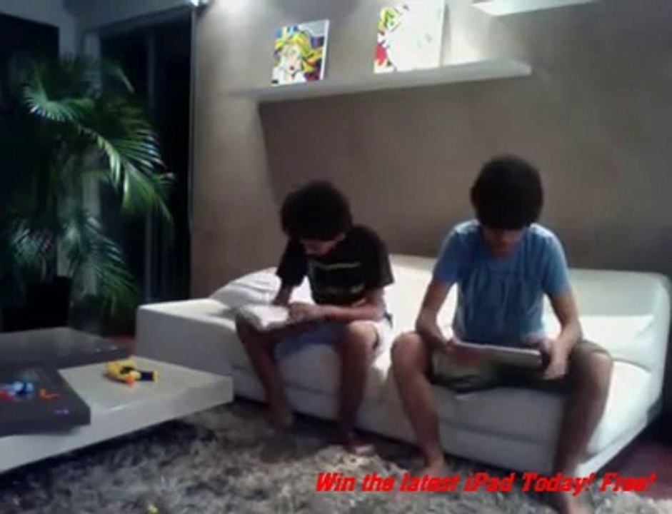 boy slaps his brother with the ipad