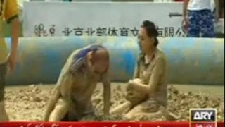 Chinese play Football in mud