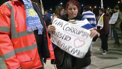Flag-waving Uruguayans flock to airport to wait for Suarez