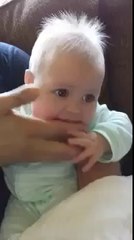 little kid make fun with the hand of father very cool.